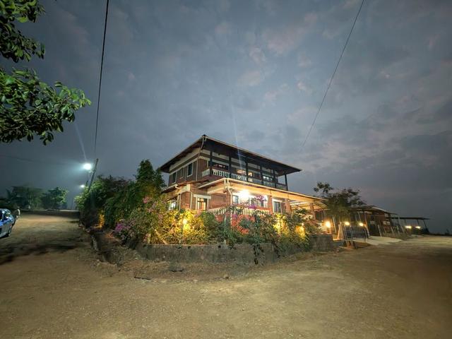 A bungalow lit up in the evening at 1000 Trees, Dapoli
