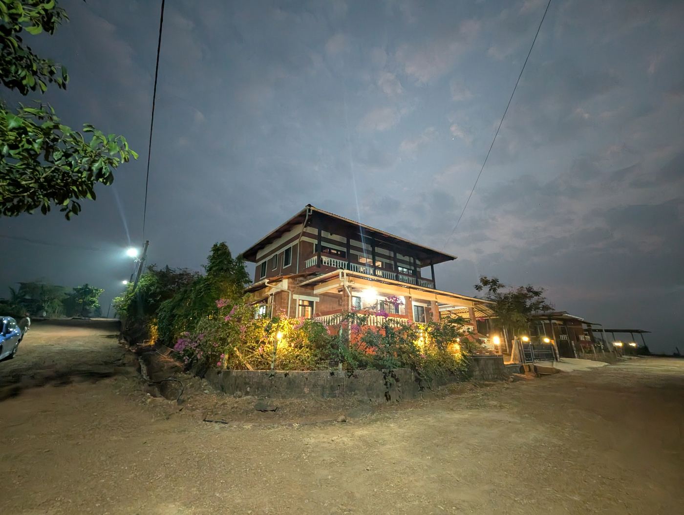 The 1BHK studio bungalow lit up in the evening at Dapoli