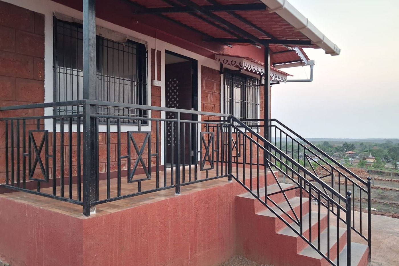 A finished bungalow in laterite stone at 1000 Trees, Dapoli