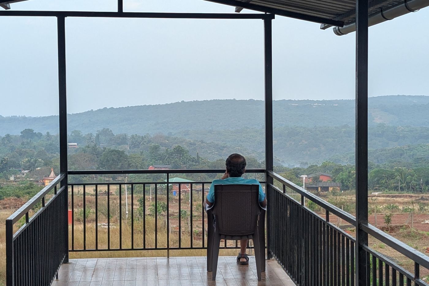 An owner on the verandah looking out over the valley