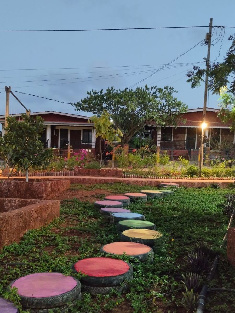 Garden pathway with painted stepping stones at Resort Dapoli