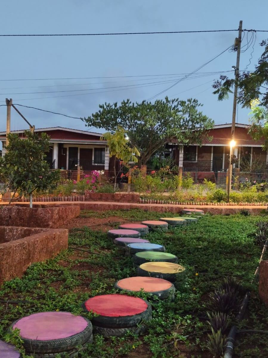 Garden pathway with painted stepping stones on site at Dapoli